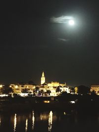 Illuminated city against sky at night