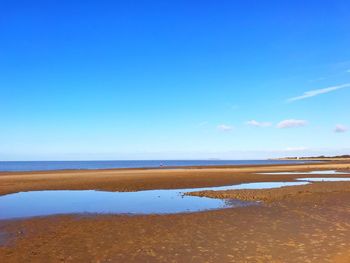 View of beach against blue sky