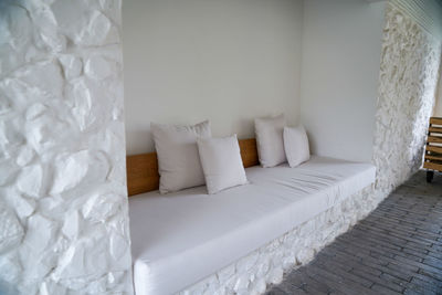 White sofa on bed against wall at home