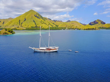 Aerial view of a yatch passing by at flores island, indonesia