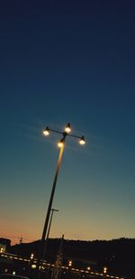 Low angle view of illuminated street light against sky at night