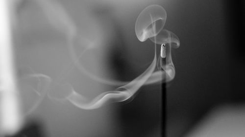 Close-up of incense emitting smoke