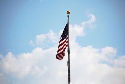 Low angle view of american flag against sky