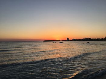 Scenic view of sea against clear sky during sunset