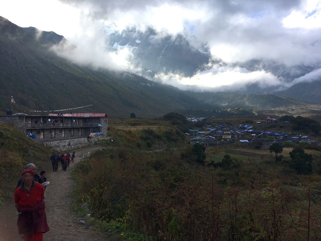 mountain, architecture, cloud - sky, sky, building exterior, real people, built structure, environment, nature, day, group of people, women, landscape, plant, building, men, people, adult, leisure activity, scenics - nature, outdoors