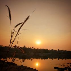 Scenic view of lake against orange sky