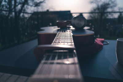 Close-up of guitar on table