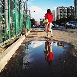 Full length of woman standing in water