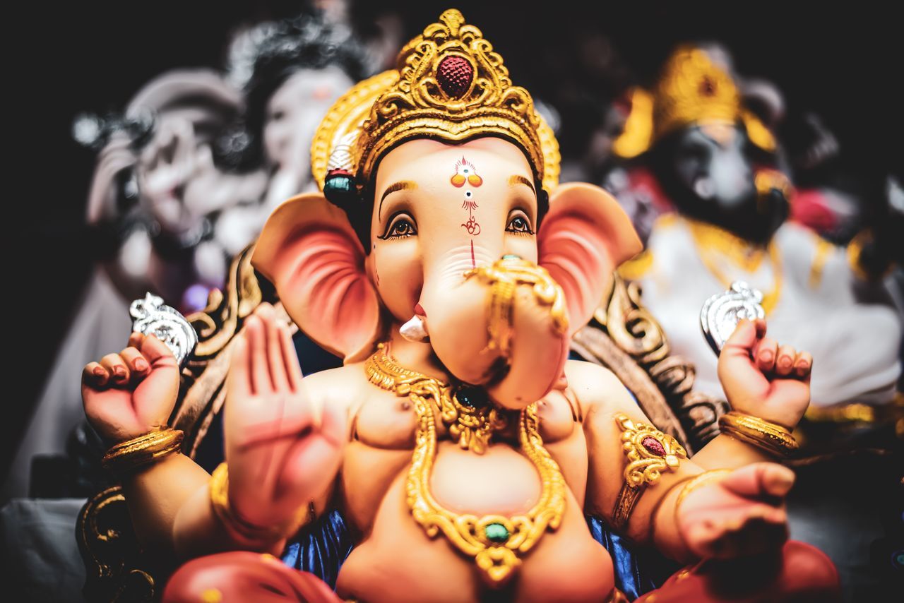 LOW ANGLE VIEW OF STATUE AGAINST TEMPLE