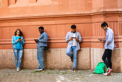 People standing against wall