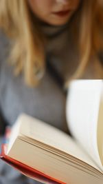 Close-up of woman reading book