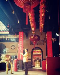 Full length of man standing in illuminated temple