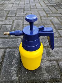 Close-up of pressure sprayer on footpath