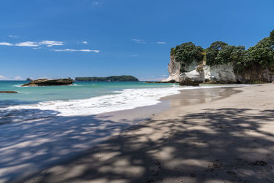 Scenic view of beach against blue sky