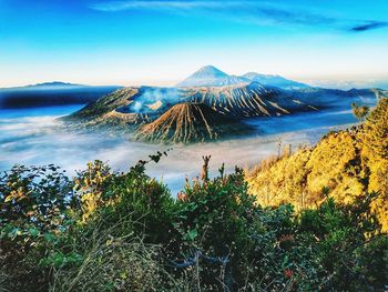 Scenic view of sea and mountains against sky