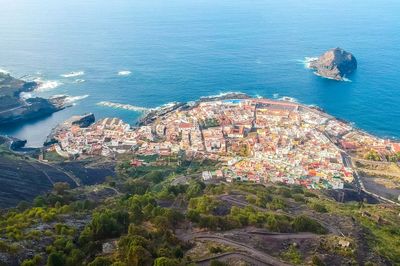 High angle view of townscape by sea