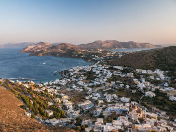 High angle view of townscape by sea against sky