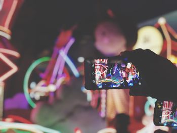 Midsection of man using mobile phone at music concert