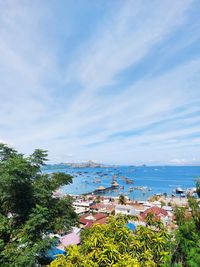 High angle view of townscape by sea against sky