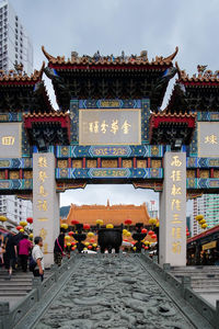 Group of people outside temple against building