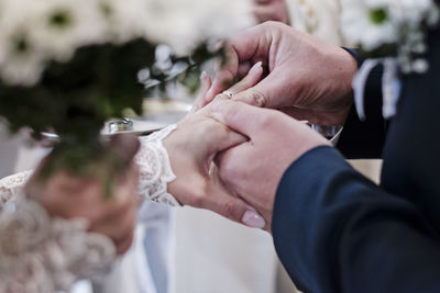 Midsection of couple holding hands