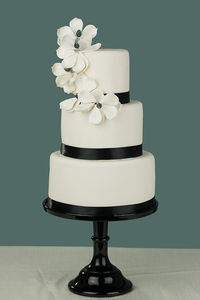 Close-up of white flowers on table against black background