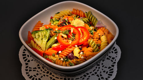 High angle view of chopped vegetables in bowl against black background