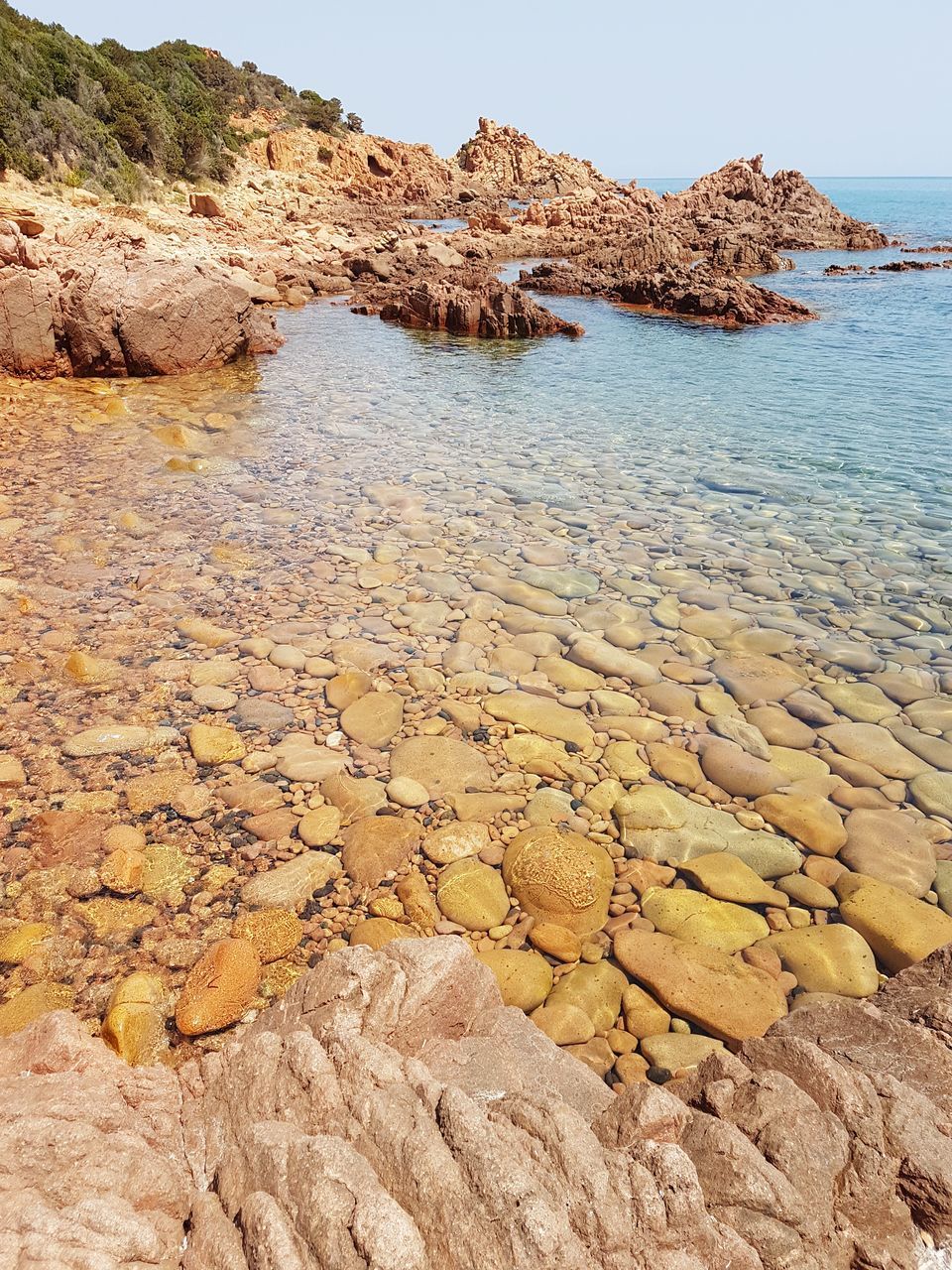 rock - object, rock formation, nature, tranquility, tranquil scene, beauty in nature, scenics, water, beach, day, outdoors, sand, no people, landscape, physical geography, sea, arid climate, yellow, sky, pebble beach