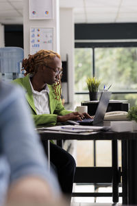 Young woman using laptop at table