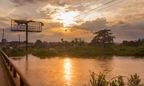 Scenic view of river against sky at sunset