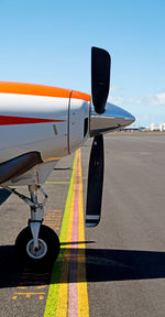 Airplane on runway against sky