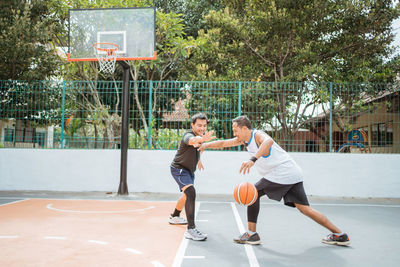 Basketball players playing at court