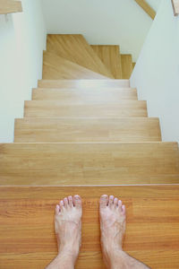 Low section of person on wooden floor