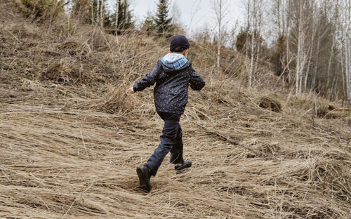 The boy runs across the field. minimalistic landscape with a running child