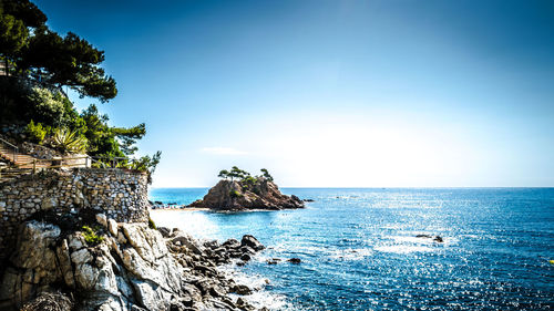 Scenic view of sea against clear blue sky