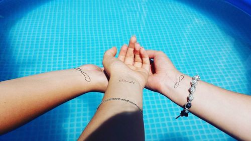 Low section of woman feet in swimming pool