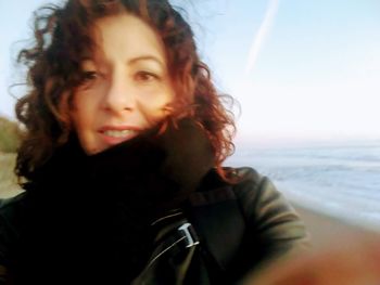 Portrait of smiling young woman on beach