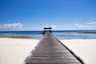 Pier over sea against sky