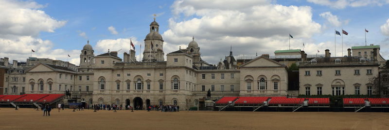 Buildings against cloudy sky