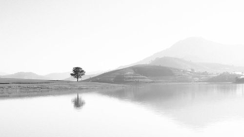 Scenic view of lake and mountains against clear sky