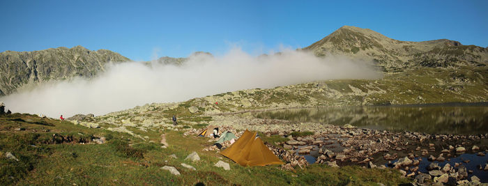 Tents on mountain against sky