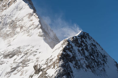 Scenic view of snow covered mountains against sky