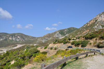 Scenic view of mountains against sky in porto flavia , sardinia