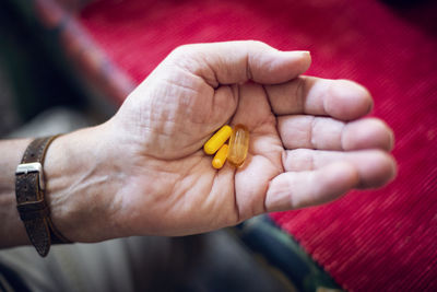 Senior holding pills in his hand