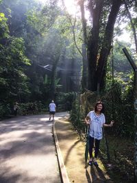 Full length of boy walking on road in forest