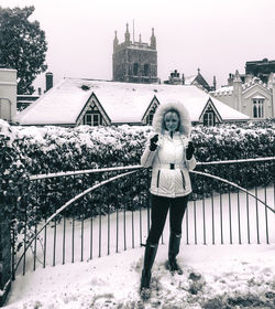 Portrait of woman standing on snow against sky