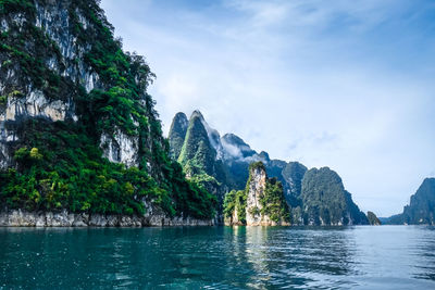 Scenic view of lake and mountains against sky