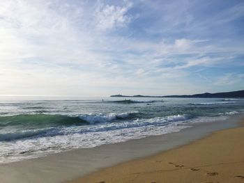 View of beach against cloudy sky