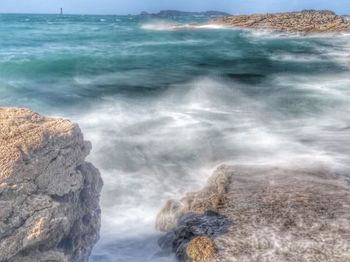 Scenic view of rocks on sea shore