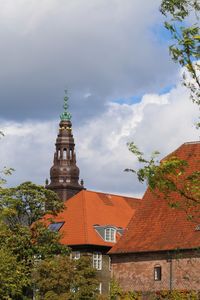 Red roofs of copenhagen central and a view to the parliament tower.